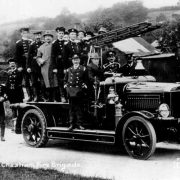 photo of people standing in old fire engine