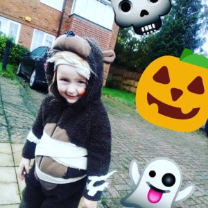 Lucy dresses as a bear with pumpkin and ghost stickers in the image