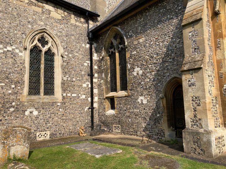 Looking towards the walls of St Mary's Church with 2 arched windows visible