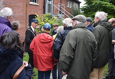 A group of older people listening to a talk during a walk around Chesham
