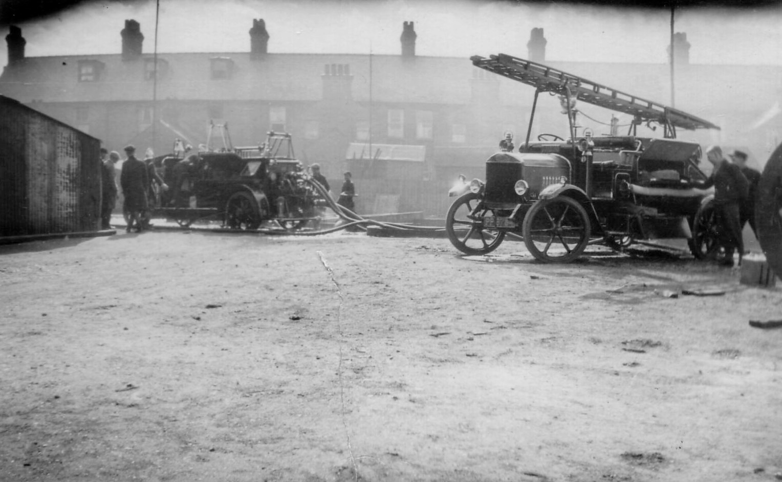 Black and white photo of 2 fire engines