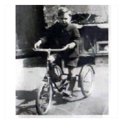 Photo of Reggie Gray on a tricycle