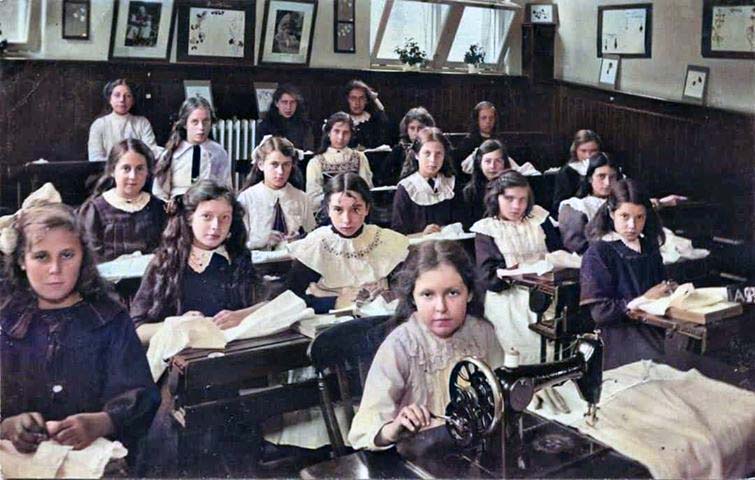 Color photo of school children working at their desks
