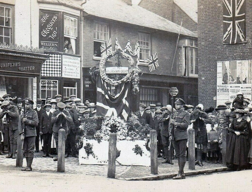 Soldiers and others gathered around a temporary war memorial