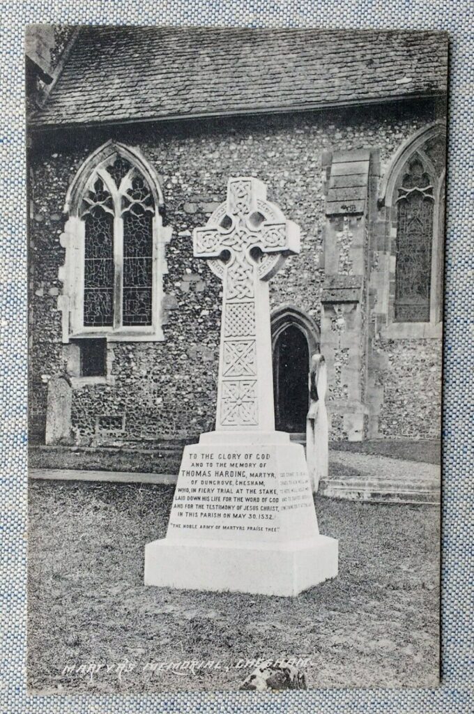 A granite cross memorial to Thomas Harding outside a church