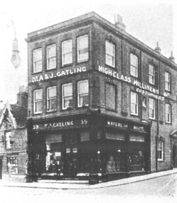 Black and white photo of a 3 story building with the signs 'MA & J Gatling'