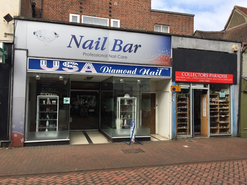 Photo of the two shop fronts USA Diamond Nail Bar and Collectors Paradise