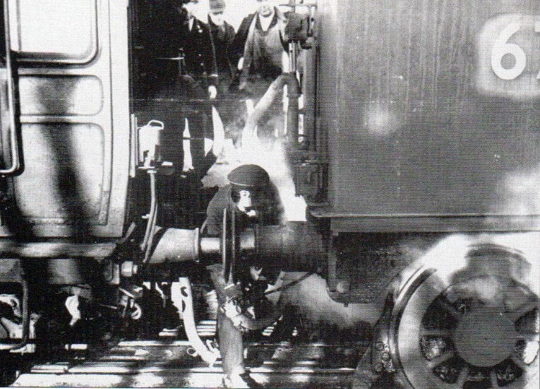 A man is changing the engine on a train