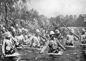 British troops wading through the river at the Battle of Modder River, November 28, 1899, during the South African War (1899–1902).