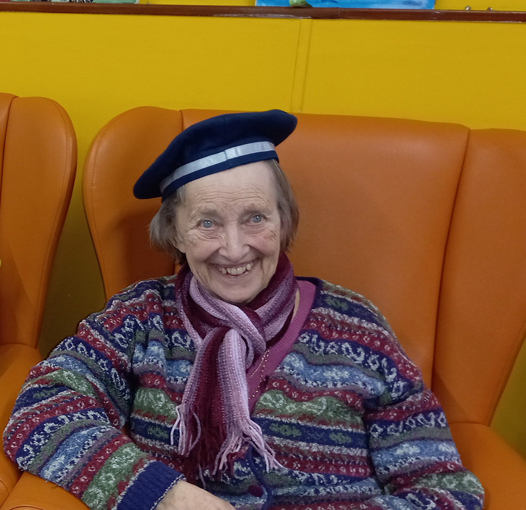 Older lady wearing a beret.